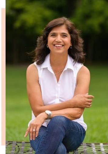D. Sangeeta, Gotara Founder & CEO. Image of D. Sangeeta seated with her arms crossed casually on her lap, facing the camera, and smiling. She has shoulder length brown, way hair and is wearing a sleeveless white collared shirt and blue jeans.